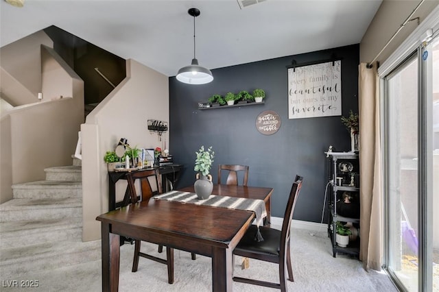 5509 Ante Up Ct Unit 102, Las Vegas, NV 89122 - dining room with light carpet, stairway, and baseboards