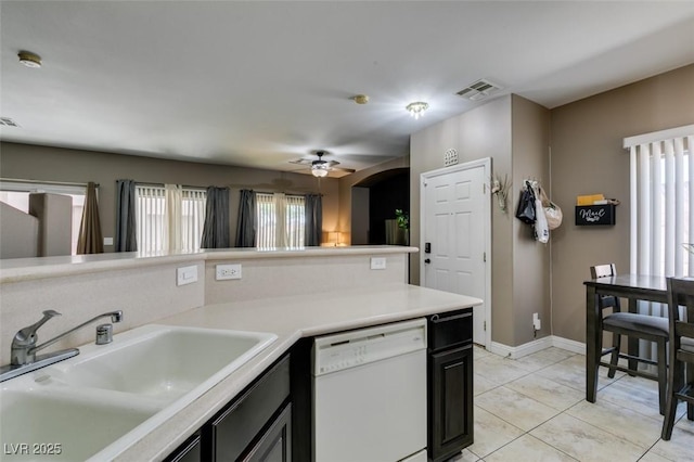 5509 Ante Up Ct Unit 102, Las Vegas, NV 89122 - kitchen with dishwasher, a sink, ceiling fan, light countertops, and baseboards
