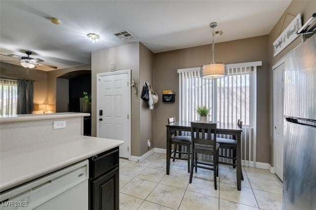 5509 Ante Up Ct Unit 102, Las Vegas, NV 89122 - kitchen featuring healthy amount of natural light, light countertops, a ceiling fan, and baseboards
