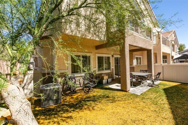 5509 Ante Up Ct Unit 102, Las Vegas, NV 89122 - rear view of property with stucco siding, a patio, and central AC unit