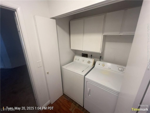 laundry area featuring cabinet space, washer and clothes dryer, and dark wood-style floors