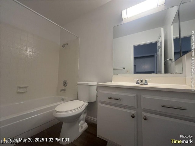 full bath with toilet, vanity, and  shower combination