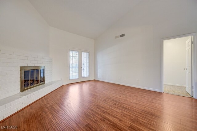 1850 Camino Verde Ln, Las Vegas, NV 89119 - unfurnished living room with high vaulted ceiling, wood finished floors, and a brick fireplace