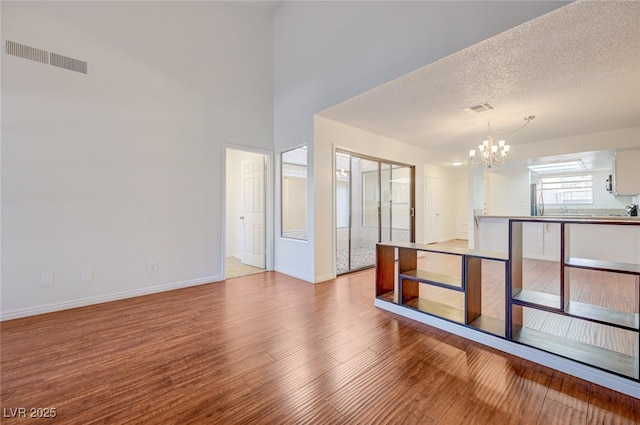 1850 Camino Verde Ln, Las Vegas, NV 89119 - unfurnished room featuring a chandelier and wood finished floors
