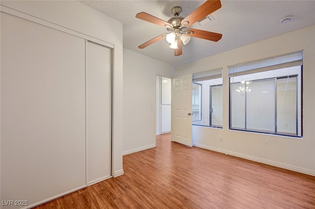 1850 Camino Verde Ln, Las Vegas, NV 89119 - unfurnished bedroom with light wood finished floors, a closet, a textured ceiling, and a ceiling fan