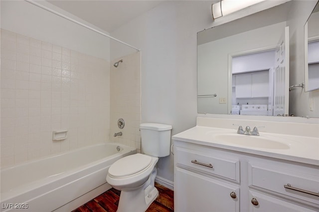 1850 Camino Verde Ln, Las Vegas, NV 89119 - bathroom with wood finished floors, washtub / shower combination, vanity, and washer / dryer