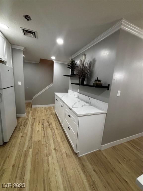 150 Greenbriar Townhouse Way, Las Vegas, NV 89121 - hallway with crown molding, light wood-style floors, and baseboards