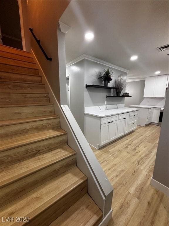 150 Greenbriar Townhouse Way, Las Vegas, NV 89121 - staircase with ornamental molding, wood finished floors, and recessed lighting