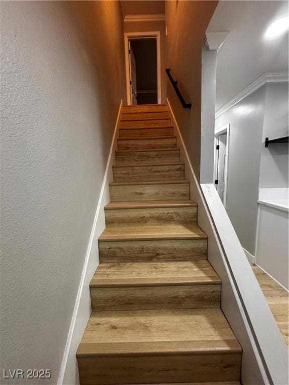 150 Greenbriar Townhouse Way, Las Vegas, NV 89121 - stairs featuring ornamental molding, a textured wall, and wood finished floors