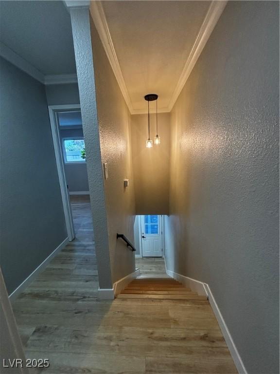 150 Greenbriar Townhouse Way, Las Vegas, NV 89121 - stairs featuring crown molding, wood finished floors, baseboards, and a textured wall