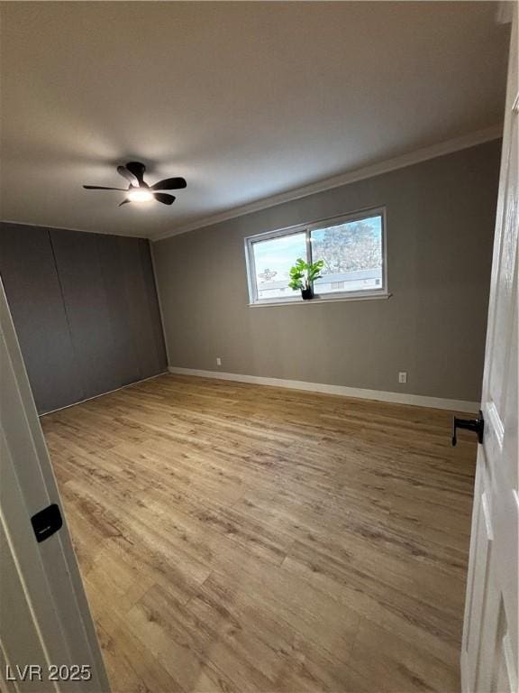 150 Greenbriar Townhouse Way, Las Vegas, NV 89121 - spare room with crown molding, light wood-style floors, baseboards, and a ceiling fan
