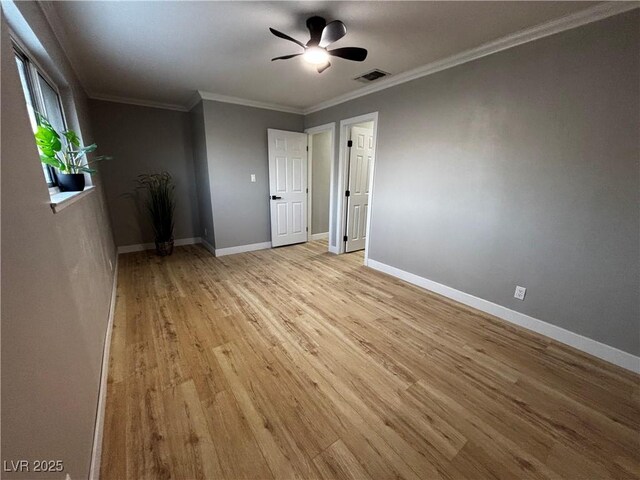 150 Greenbriar Townhouse Way, Las Vegas, NV 89121 - spare room with light wood-type flooring, ceiling fan, baseboards, and crown molding