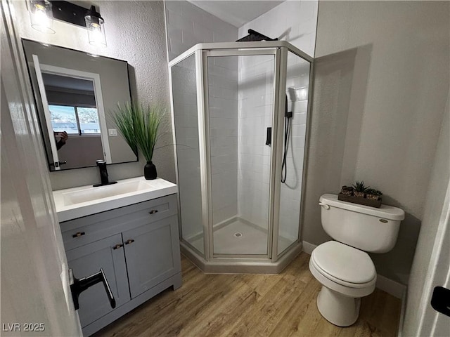 150 Greenbriar Townhouse Way, Las Vegas, NV 89121 - full bath with wood finished floors, a shower stall, toilet, vanity, and a textured wall