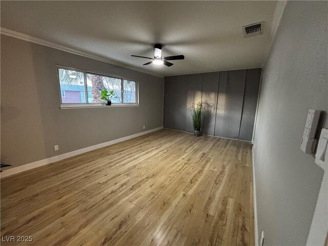 150 Greenbriar Townhouse Way, Las Vegas, NV 89121 - unfurnished room with a ceiling fan, crown molding, light wood finished floors, and baseboards
