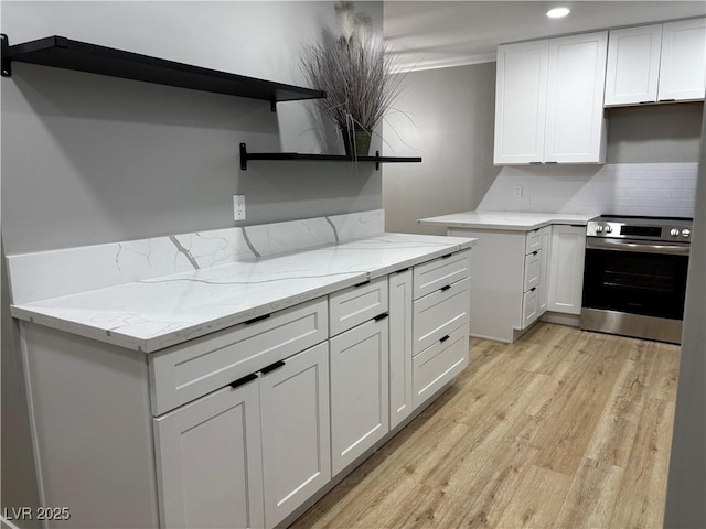 150 Greenbriar Townhouse Way, Las Vegas, NV 89121 - kitchen featuring open shelves, stainless steel electric range, backsplash, light wood-style flooring, and light stone counters