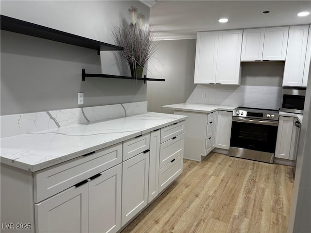150 Greenbriar Townhouse Way, Las Vegas, NV 89121 - kitchen featuring appliances with stainless steel finishes, open shelves, light wood-type flooring, white cabinets, and crown molding