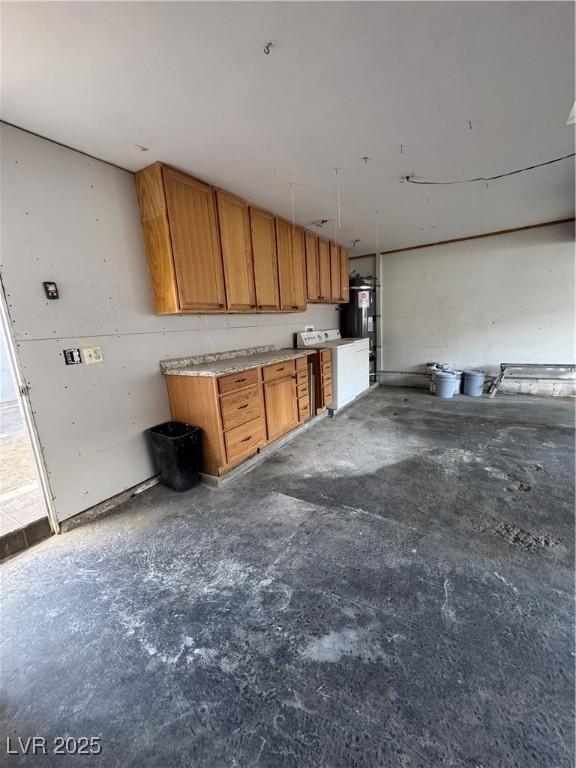 150 Greenbriar Townhouse Way, Las Vegas, NV 89121 - kitchen with unfinished concrete flooring and brown cabinetry