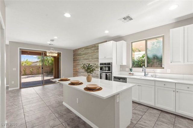 11847 Corenzio Ave, Las Vegas, NV 89138 - kitchen with a sink, stainless steel appliances, light countertops, recessed lighting, and a chandelier