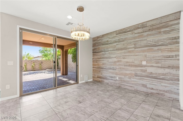 11847 Corenzio Ave, Las Vegas, NV 89138 - spare room featuring an accent wall, a chandelier, and baseboards