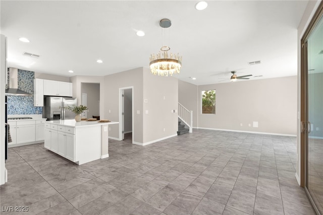 11847 Corenzio Ave, Las Vegas, NV 89138 - kitchen featuring stainless steel fridge with ice dispenser, wall chimney range hood, tasteful backsplash, ceiling fan, and black electric stovetop