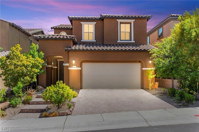 11847 Corenzio Ave, Las Vegas, NV 89138 - mediterranean / spanish-style home with driveway, a tiled roof, stucco siding, and an attached garage