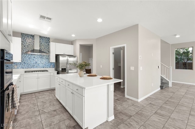 11847 Corenzio Ave, Las Vegas, NV 89138 - kitchen with stainless steel appliances, wall chimney range hood, light countertops, tasteful backsplash, and a center island