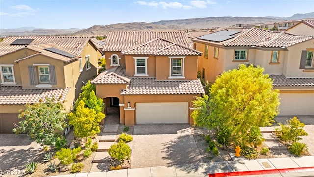 11847 Corenzio Ave, Las Vegas, NV 89138 - mediterranean / spanish home featuring a mountain view, an attached garage, a tile roof, stucco siding, and driveway