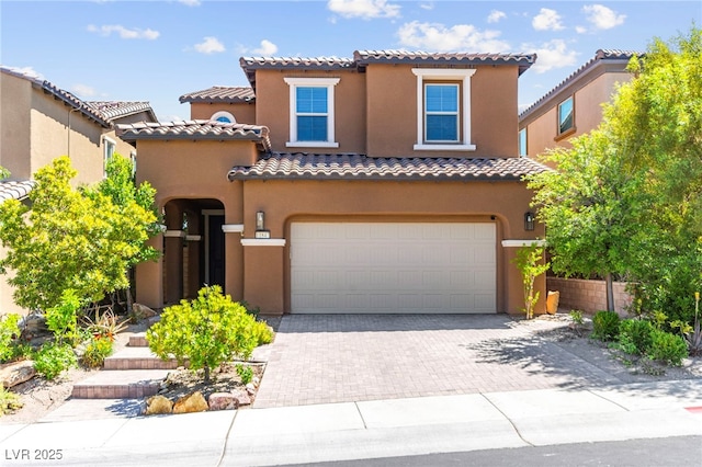 11847 Corenzio Ave, Las Vegas, NV 89138 - mediterranean / spanish house with a tile roof, driveway, stucco siding, and an attached garage