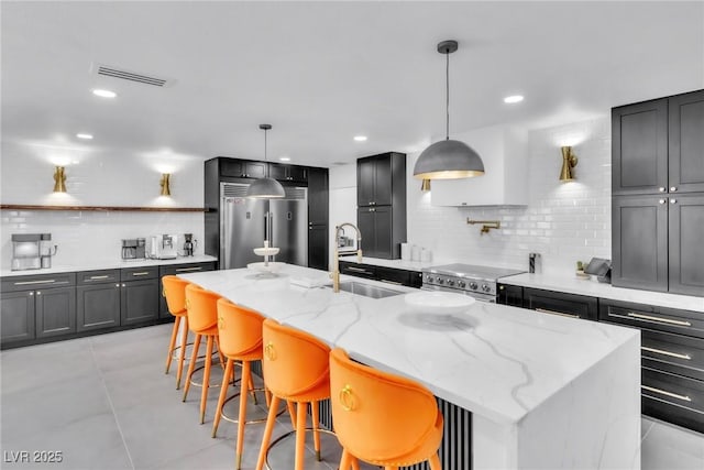 3189 Montecito Dr, Las Vegas, NV 89120 - kitchen featuring a sink, appliances with stainless steel finishes, decorative backsplash, light stone counters, and recessed lighting