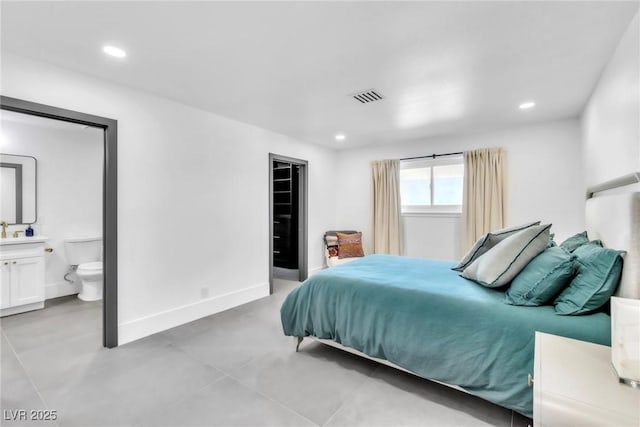 3189 Montecito Dr, Las Vegas, NV 89120 - bedroom with recessed lighting, finished concrete floors, baseboards, and connected bathroom
