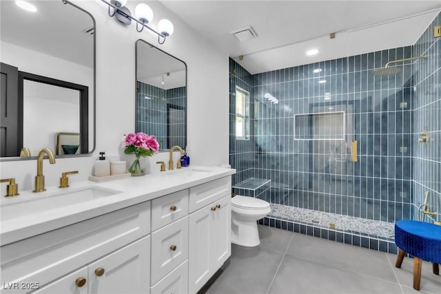 3189 Montecito Dr, Las Vegas, NV 89120 - bathroom featuring tile patterned floors, tiled shower, double vanity, and toilet