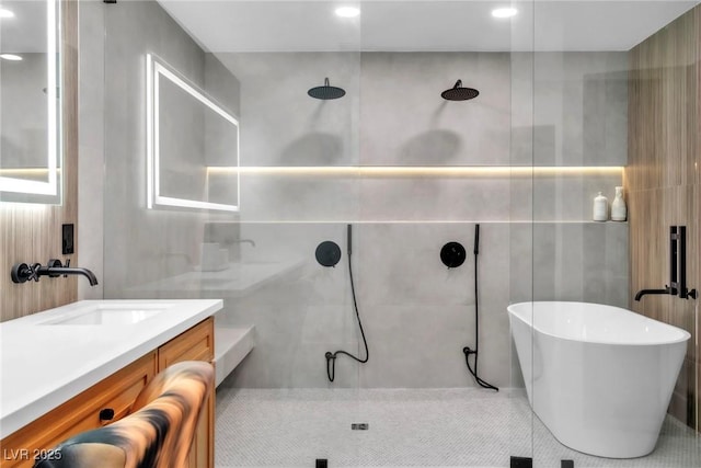 3189 Montecito Dr, Las Vegas, NV 89120 - bathroom with tile walls, a tile shower, vanity, recessed lighting, and a freestanding tub