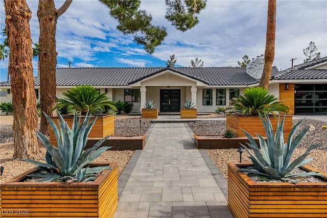3189 Montecito Dr, Las Vegas, NV 89120 - view of front facade featuring french doors, stucco siding, and a tiled roof