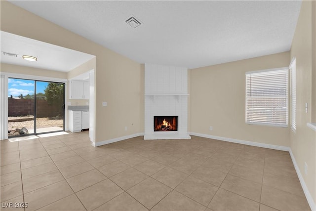 542 Grimsby Ave, Henderson, NV 89014 - unfurnished living room with light tile patterned floors, a brick fireplace, and baseboards