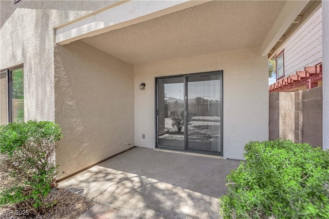 542 Grimsby Ave, Henderson, NV 89014 - doorway to property with stucco siding and a patio