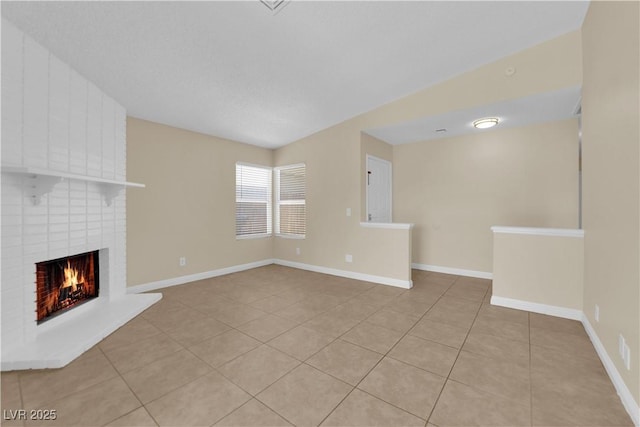 542 Grimsby Ave, Henderson, NV 89014 - unfurnished living room with a brick fireplace, light tile patterned flooring, and baseboards