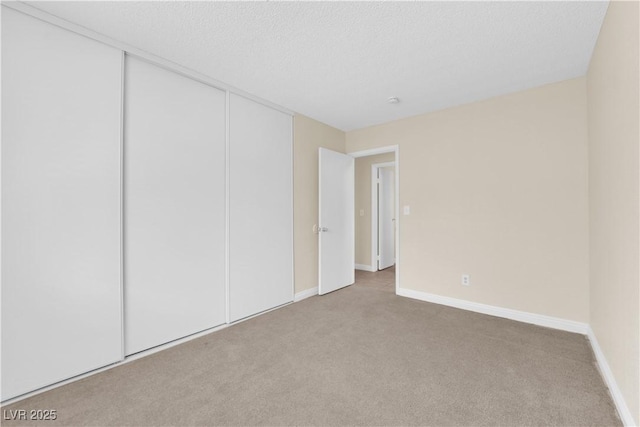 542 Grimsby Ave, Henderson, NV 89014 - unfurnished bedroom featuring carpet floors, baseboards, a closet, and a textured ceiling