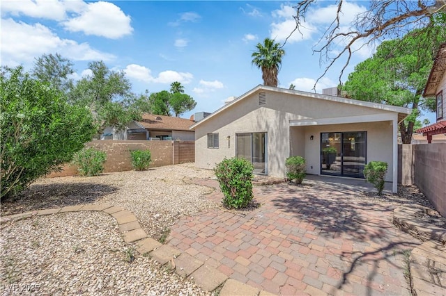 542 Grimsby Ave, Henderson, NV 89014 - rear view of house with stucco siding, a patio area, and a fenced backyard