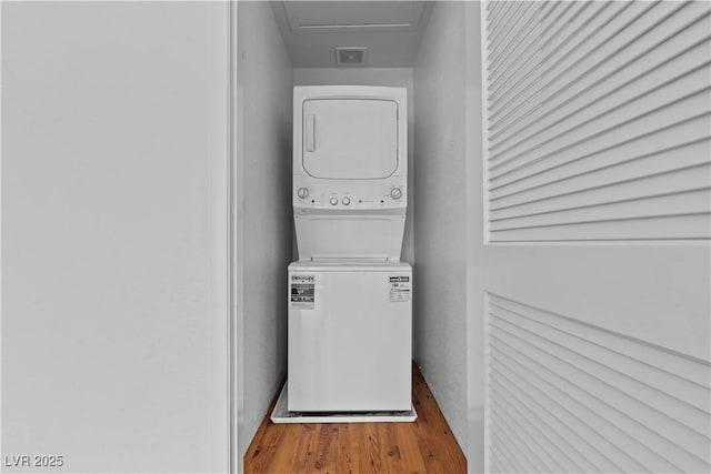 2596 Lazy Saddle Dr, Henderson, NV 89002 - laundry room featuring stacked washer / drying machine, wood finished floors, and baseboards