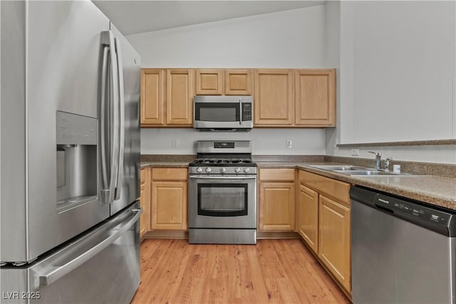 2596 Lazy Saddle Dr, Henderson, NV 89002 - kitchen featuring appliances with stainless steel finishes, vaulted ceiling, light wood-style flooring, a sink, and light brown cabinets