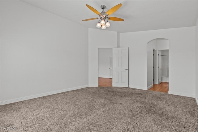2596 Lazy Saddle Dr, Henderson, NV 89002 - carpeted spare room featuring arched walkways, a ceiling fan, and baseboards
