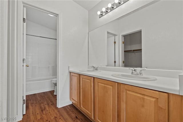 2596 Lazy Saddle Dr, Henderson, NV 89002 - bathroom featuring double vanity, wood finished floors, toilet, and shower / bathtub combination