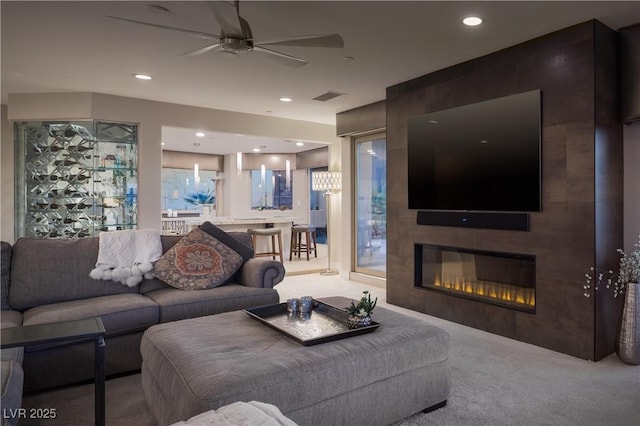 1683 Tangiers Dr, Henderson, NV 89012 - carpeted living area featuring ceiling fan, a fireplace, and recessed lighting