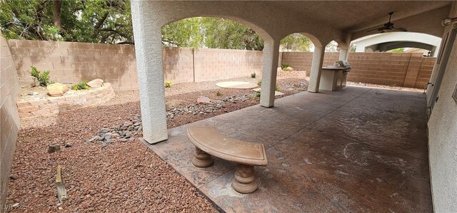 3750 Morning Canyon St, Las Vegas, NV 89147 - fenced backyard with ceiling fan and a patio