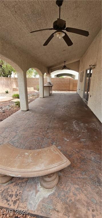3750 Morning Canyon St, Las Vegas, NV 89147 - fenced backyard with ceiling fan and a patio area
