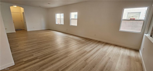 3750 Morning Canyon St, Las Vegas, NV 89147 - spare room featuring arched walkways, wood finished floors, and baseboards