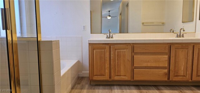 3750 Morning Canyon St, Las Vegas, NV 89147 - full bathroom featuring wood finished floors, a garden tub, a ceiling fan, double vanity, and a shower with door