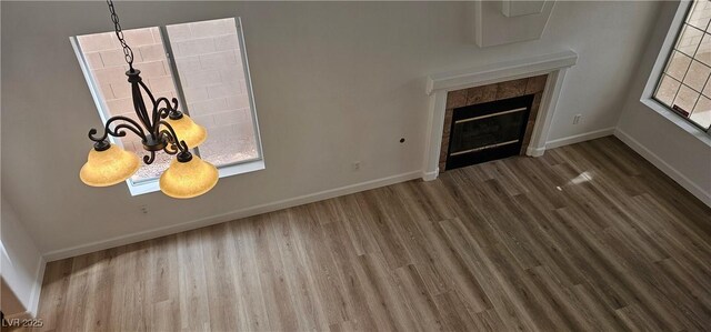 3750 Morning Canyon St, Las Vegas, NV 89147 - unfurnished living room with wood finished floors, baseboards, and a tiled fireplace