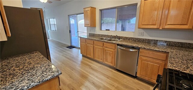 3750 Morning Canyon St, Las Vegas, NV 89147 - kitchen with appliances with stainless steel finishes, light wood finished floors, ceiling fan, a sink, and dark stone counters