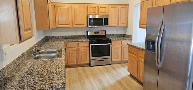 3750 Morning Canyon St, Las Vegas, NV 89147 - kitchen featuring stainless steel appliances, a sink, light wood-style flooring, and light brown cabinets